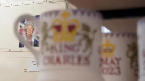 PA Media King Charles III themed mugs on display during the production of hand-decorated pieces from the forthcoming Coronation collection, at the Emma Bridgewater Pottery Factory in Stoke on Trent.
