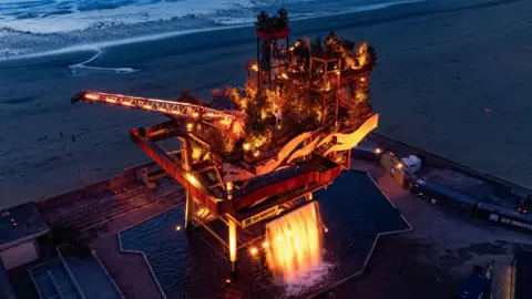 PA Media A decommissioned offshore platform on Weston-super-Mare"s seafront has been transformed into one of the UK's largest public art installations, entitled See Monster, as part of Unboxed