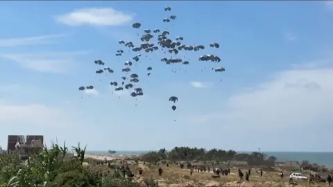 Aid parachutes fall near the coast of northern Gaza