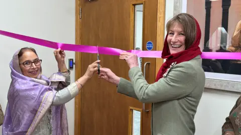 BBC Two women smiling and cutting a ribbon