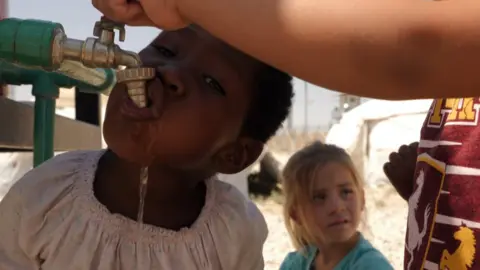 Jewan Abdi Child drinking from a water tap
