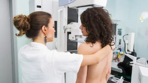 Getty Images Young woman gets breasts checked