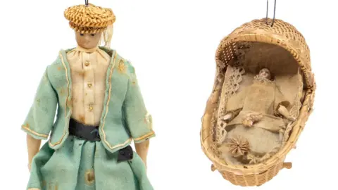 Hansons Auctioneers The doll inside a woven crib and wax doll missing a leg which had been owned by Queen Victoria