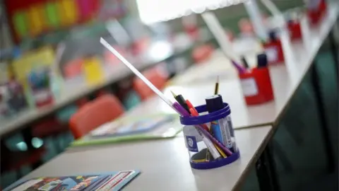 Reuters Empty desks in a classroom