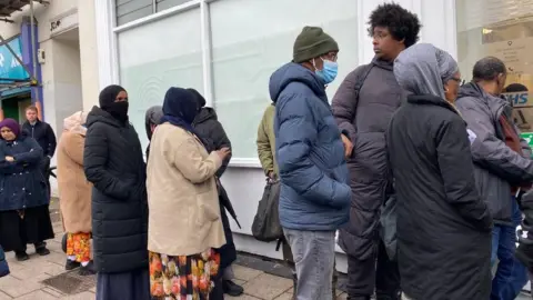 People queueing for dentist practice in St Pauls in Bristol