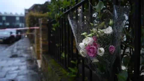 PA Media Floral tributes in Battersea Church Road, south London