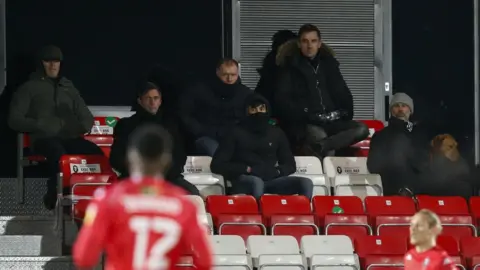 Getty Images Gary Neville (top) watches Salford City at their Moor Lane stadium earlier in 2021