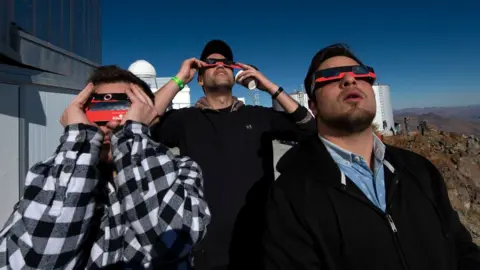 AFP People watch a solar eclipse at La Silla European Southern Observatory (ESO) in La Higuera, Coquimbo Region, Chile