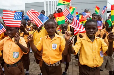 AFP Children wave the American and Ghana flags for US First Lady Melania Trump during an arrival ceremony after landing at Kotoka International Airport in Accra October 2, 2018 as she begins her week long trip to Africa to promote her 'Be Best' campaign.