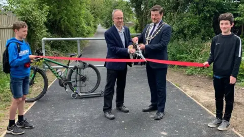 Tim baker and Andrew Cowie cutting a ribbon