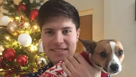Family handout Adam Ellison with a dog