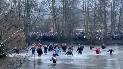 Luke Rushbrooke Players chase the ball in the water