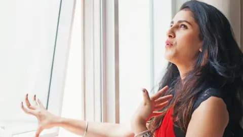 Woman opening window due to extreme heat