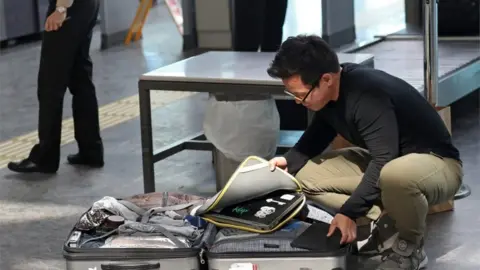 EPA Man packing suitcase