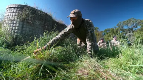 BBC Ukrainian solder on the ground during training