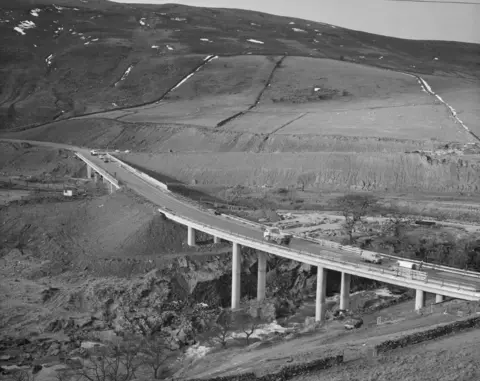 Historic England/John Laing A view of the construction of the M6 Motorway through the Lune Gorge, showing the Roger Howe bridge carrying the A685 over the River Lune on 27 February, 1970