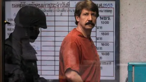 Reuters Alleged arms smuggler Viktor Bout from Russia is escorted by a member of the special police unit as he arrives at a criminal court in Bangkok October 4, 2010