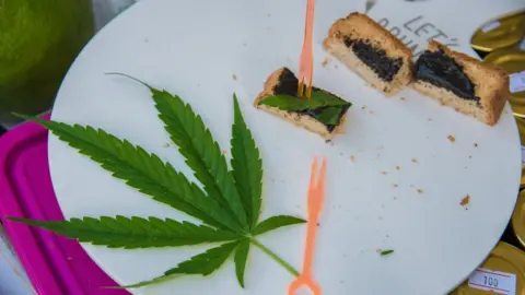 SOPA Images/Getty Images A cannabis leaf seen on a plate of a cannabis toast during a Thai food fair