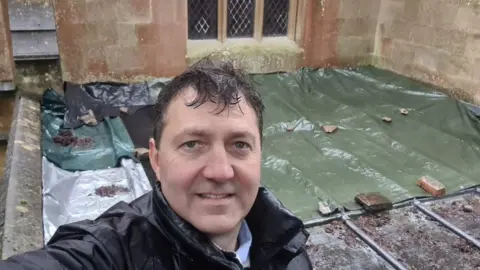 Rev Tom Yacomeni A rev on top of a roof that has had its lead stolen
