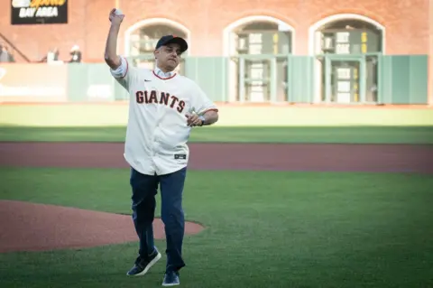 PA Media Sadiq Khan pitching a ball