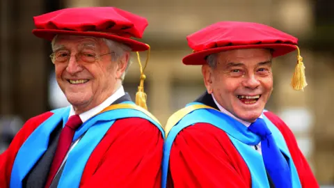 PA Media Sir Michael Parkinson (left) and Dickie Bird at the Huddersfield University campus in Barnsley, where they received honorary doctorates, 2008