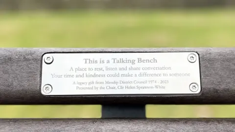 Mendip District Council a plaque on a park bench saying it's a talking bench