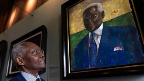 PA Media Professor Sir Geoff Palmer looking at a portrait of himself