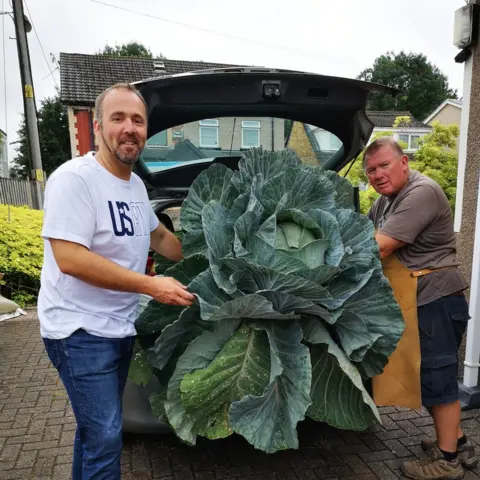 Kevin Fortey Kevin Fortey (left) with a giant cabbage
