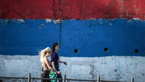 AFP people walk in belgrade