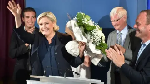 AFP FN leader Marine Le Pen waves to her supporters in Henin-Beaumont on 18 June