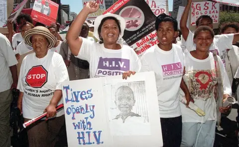 AFP Hundreds of South Africans march to parliament wearing t-shirts saying HIV positive through the centre of Cape Town on 12 February 2001