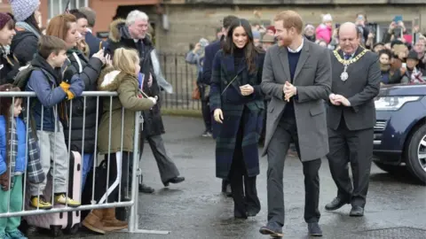 PA Prince Harry and Meghan Markle during a walkabout on the esplanade at Edinburgh Castle