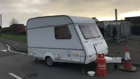 Caravan next to the Banksy artwork