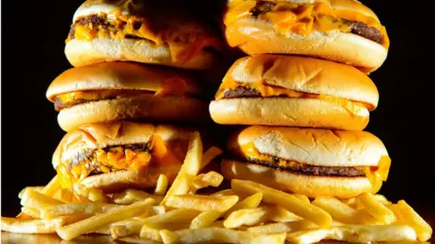 PA A pile of cheeseburgers and chips