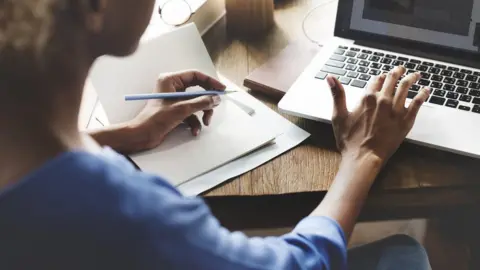 Thinkstock Woman working on a laptop