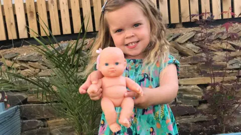 Jo Blanchard Young girl holding her doll