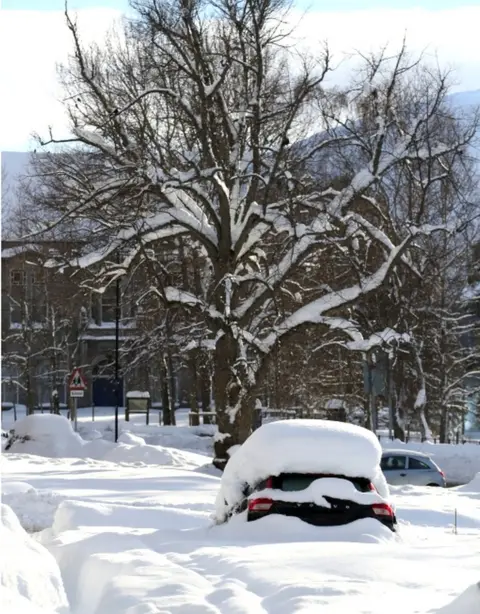 PA Media snow-covered cars