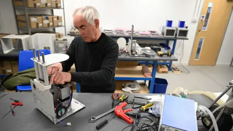 EPA Medical ventilators are constructed at the OES medical supply company in Witney, central Britain, 23 March 2020.