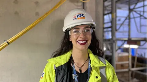 BBC Woman in PPE on nuclear power station building site