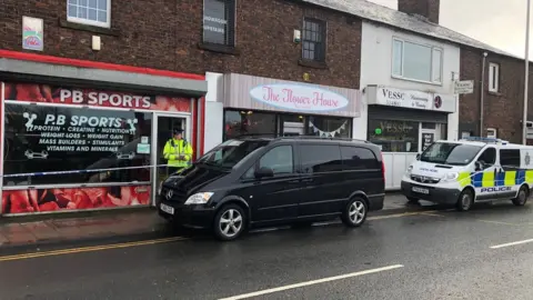 BBC A police van parked outside PB Sports