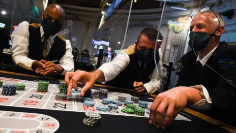 PA Media Staff wearing personal protective equipment run through a game of roulette at The Rialto casino in central London