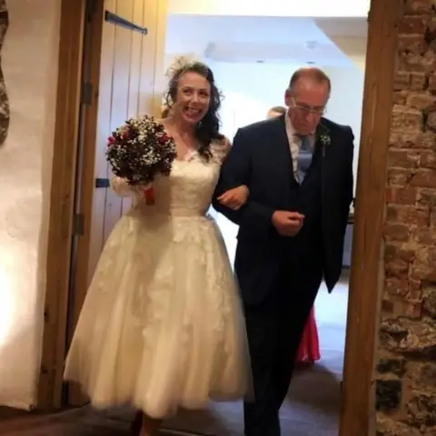 Jason Williams Photography Natasha arm in arm with her father, Richard, at her wedding