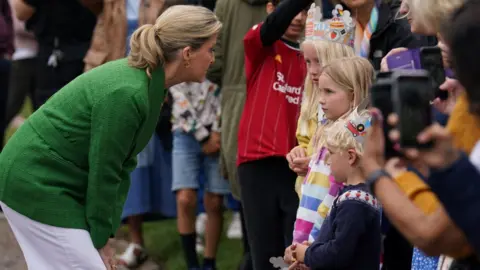 PA Media The Countess of Wessex chats to some children at the Jubilee Big Lunch party in Windsor