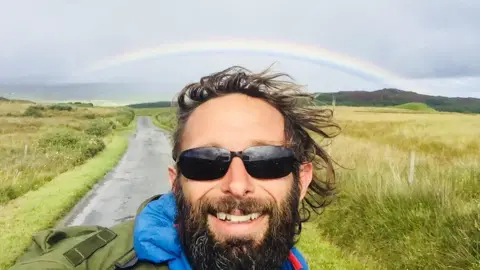 Chris Lewis  Chris with a rainbow behind him