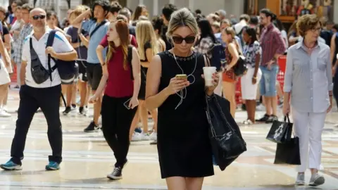 Reuters Woman using smartphone