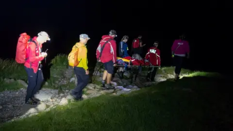 Keswick Mountain Rescue Team Harley being stretchered down by the rescue team