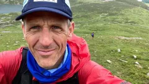 Kirk Wandsworth Kirk takes a selfie on a mountain