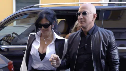 Getty Images Jeff Bezos and partner Lauren Sanchez at Milan Fashion Week.