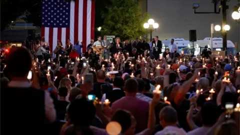 Reuters Local and state politicians and business leaders join community members for a vigil at the scene of a mass shooting in Dayton