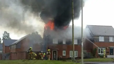 Michael Prosser Hirwaun house fire showing flames coming from the roof